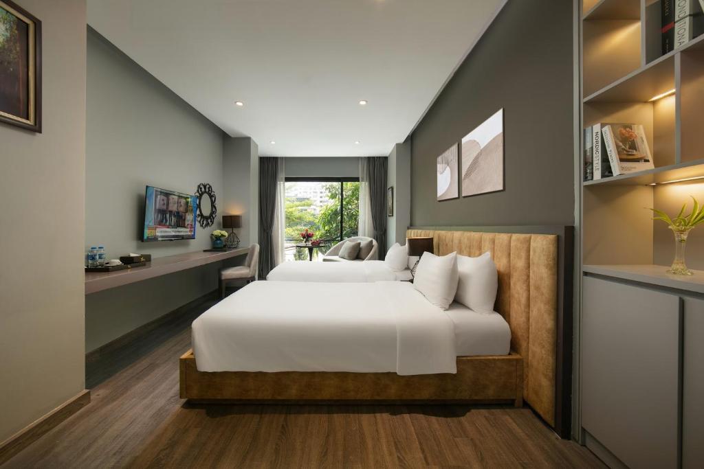 Postel nebo postele na pokoji v ubytování Hanoi Ping Luxury Hotel