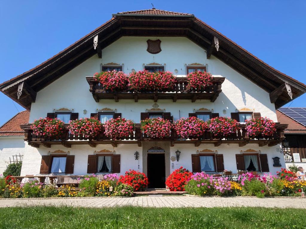 a building with flower boxes on the side of it at Barmbichlhof in Anger