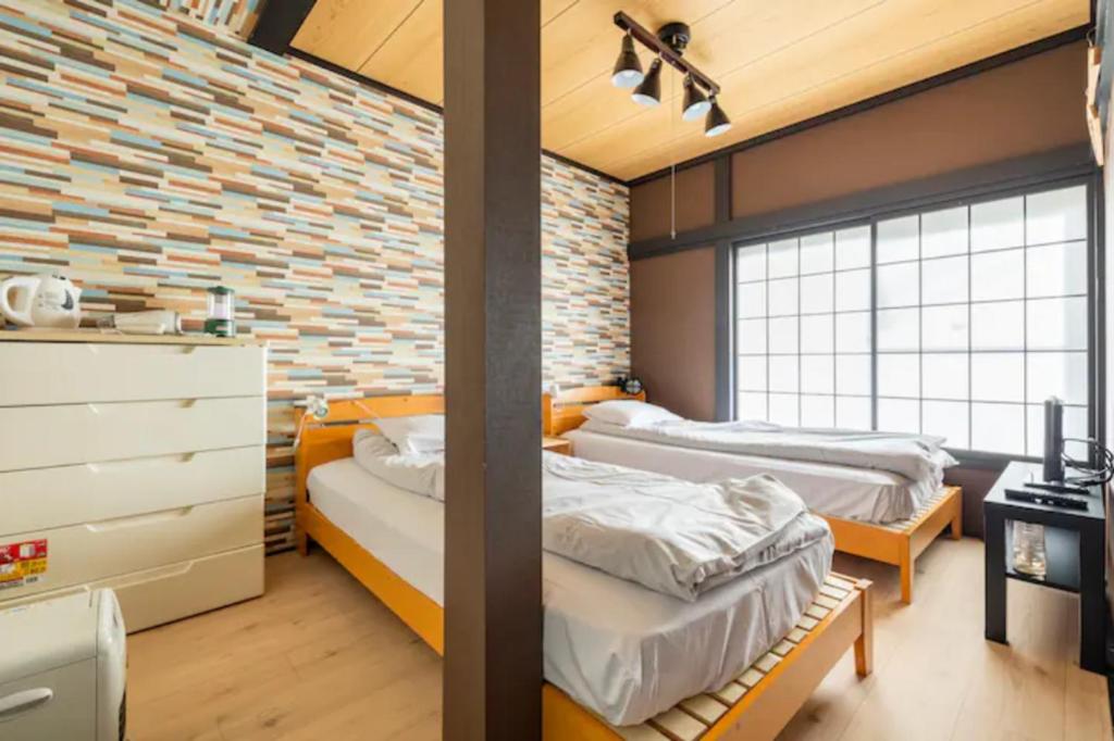 Postel nebo postele na pokoji v ubytování ザホテル湯沢スターダスト