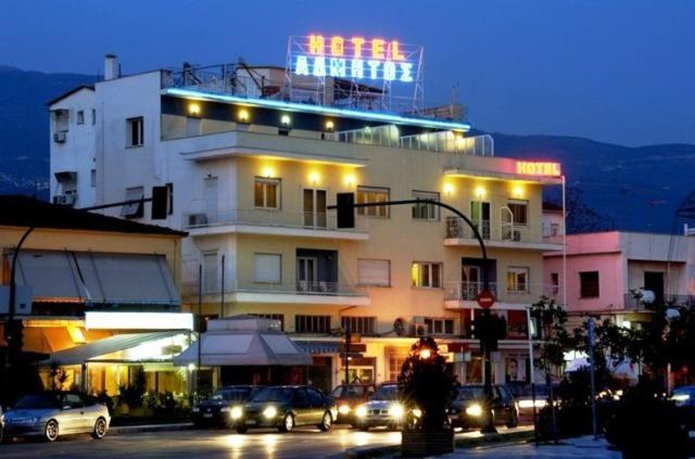 a building with a neon sign on top of it at Hotel Admitos in Volos