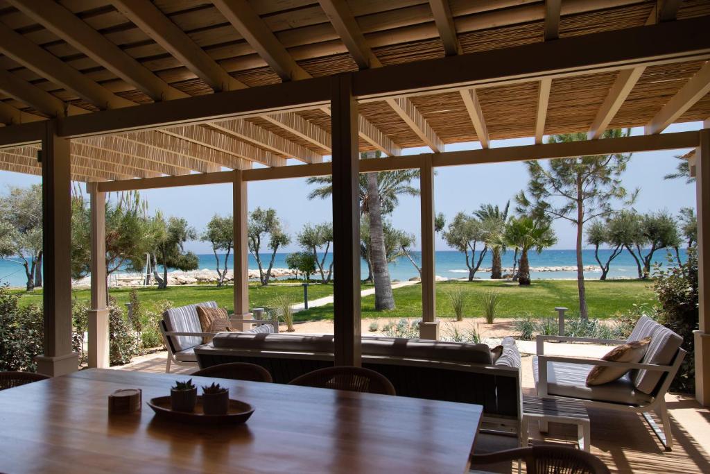 a view of the beach from the porch of a beach house at Elya Beach Luxury Suites in Ayios Theodhoros