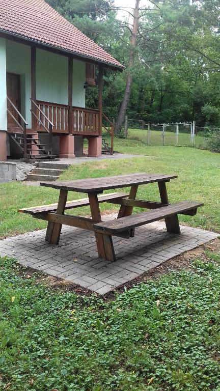 a wooden picnic table sitting on a brick slab at Chata in Nemečky