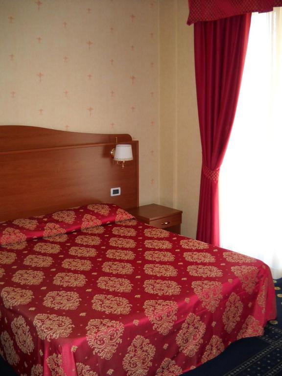 Postel nebo postele na pokoji v ubytování Hotel Rigolfo