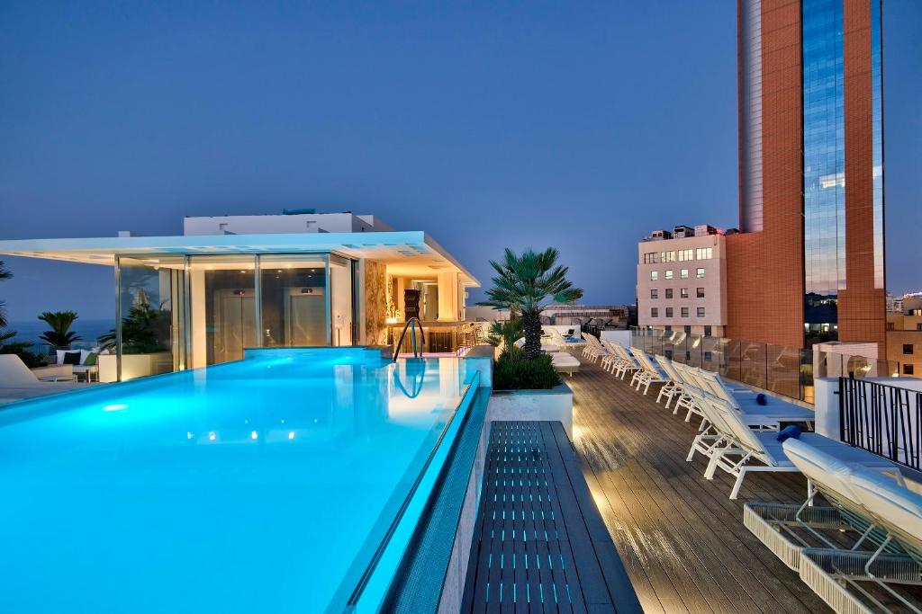a swimming pool on the roof of a building at Hotel Valentina in St Julian's