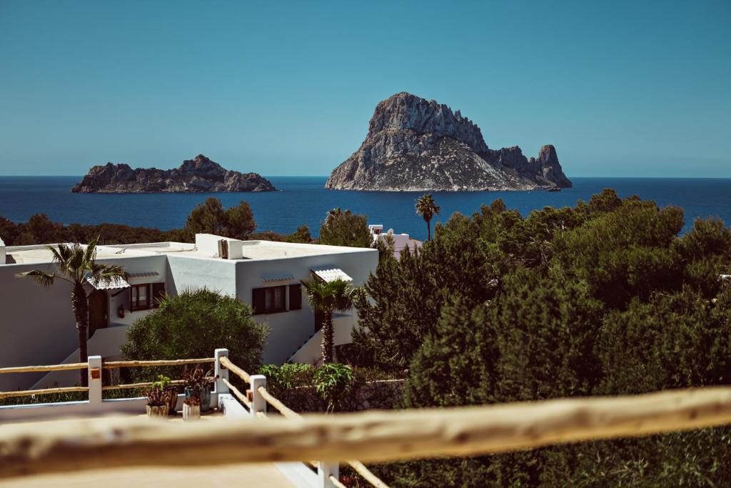 a white house with a view of the ocean at Petunia Ibiza, a Beaumier hotel in Cala Vadella