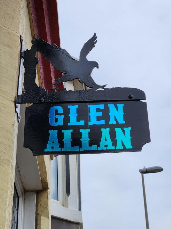 a sign on the side of a building with two birds on it at Glen Allan in Blackpool