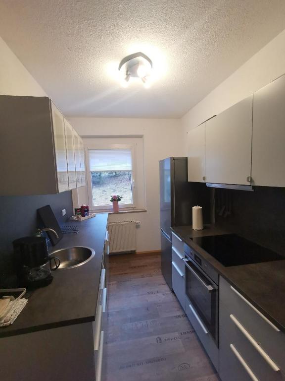 a kitchen with a sink and a counter top at Ferienwohnung Bimmelbahn Blick in Kurort Oberwiesenthal
