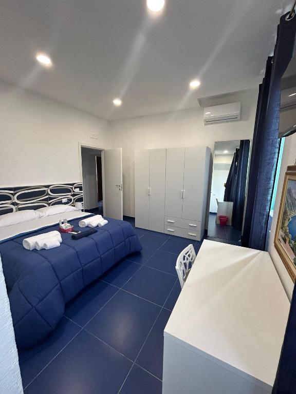 a bedroom with a blue bed in a room at la divina bed&breakfast in Battipaglia