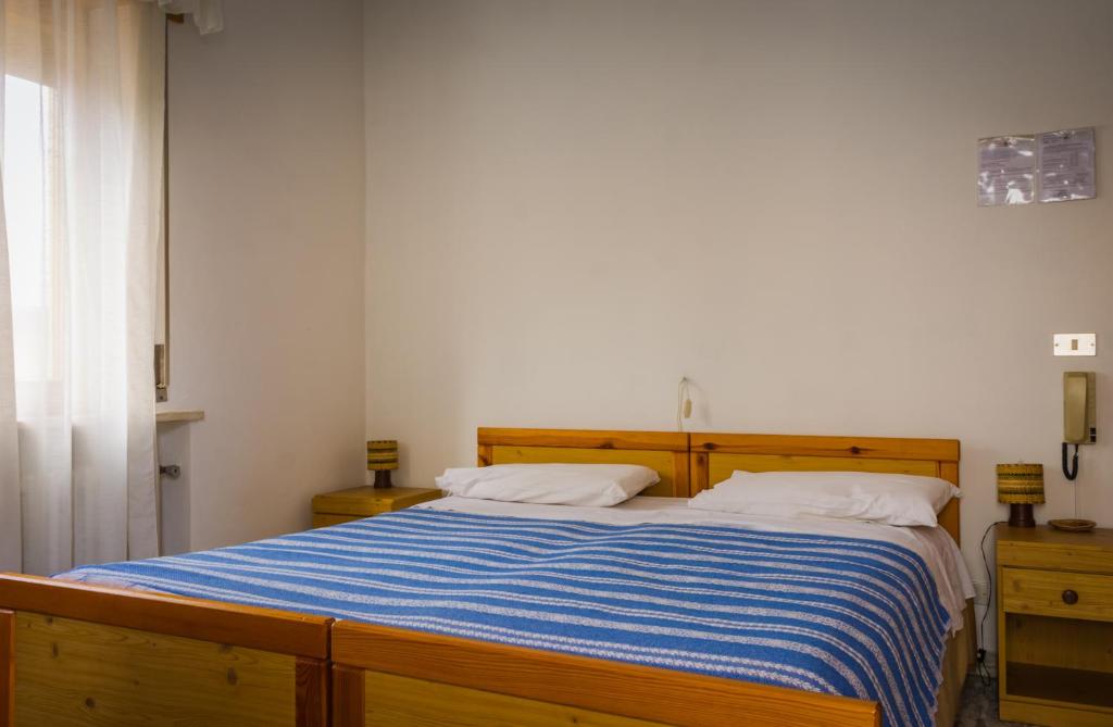 Postel nebo postele na pokoji v ubytování Albergo Speranza