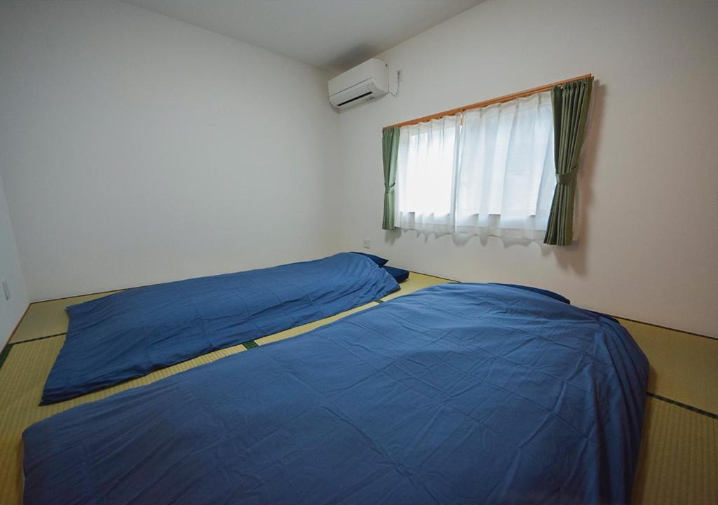 Postel nebo postele na pokoji v ubytování 渚泊 RENAClDO 浜や