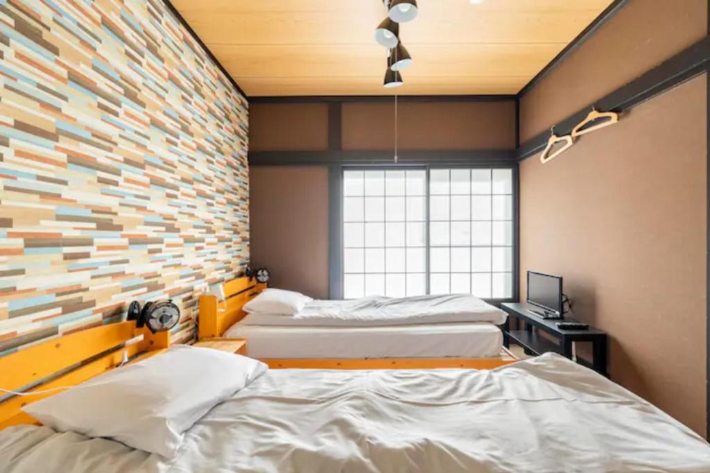 Postel nebo postele na pokoji v ubytování ザホテル湯沢スターダスト