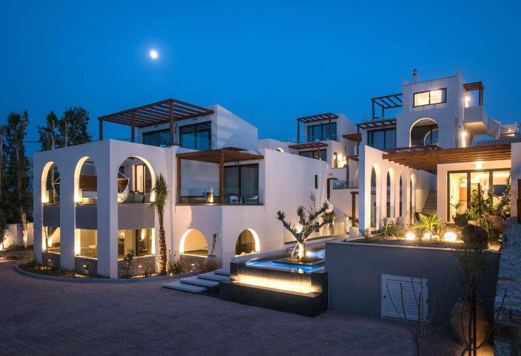 una gran casa blanca por la noche con luces en Vaya Suites by Omilos Hotels, en Amoudara Herakliou