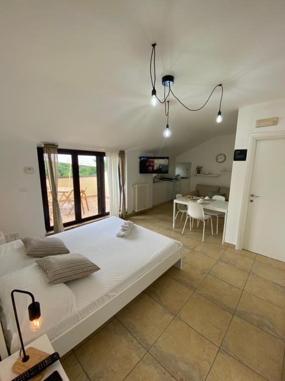 a bedroom with a large bed and a dining room at ATTICO con TERRAZZO panoramico MAIELLA - 1piano - VASTO in Vasto