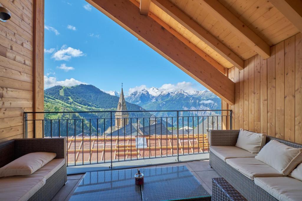 a room with a balcony with a view of mountains at La Grange in LʼHuez