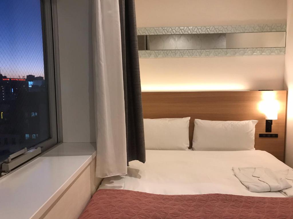 Tosei Hotel Cocone Ueno房間的床
