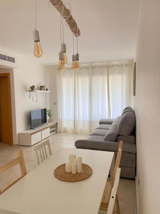 a living room with a table and a couch at Casa Roberto - Golf y relax in San Jorge