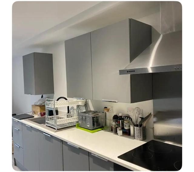 a kitchen with white cabinets and a counter top at The Hideout in Trearddur