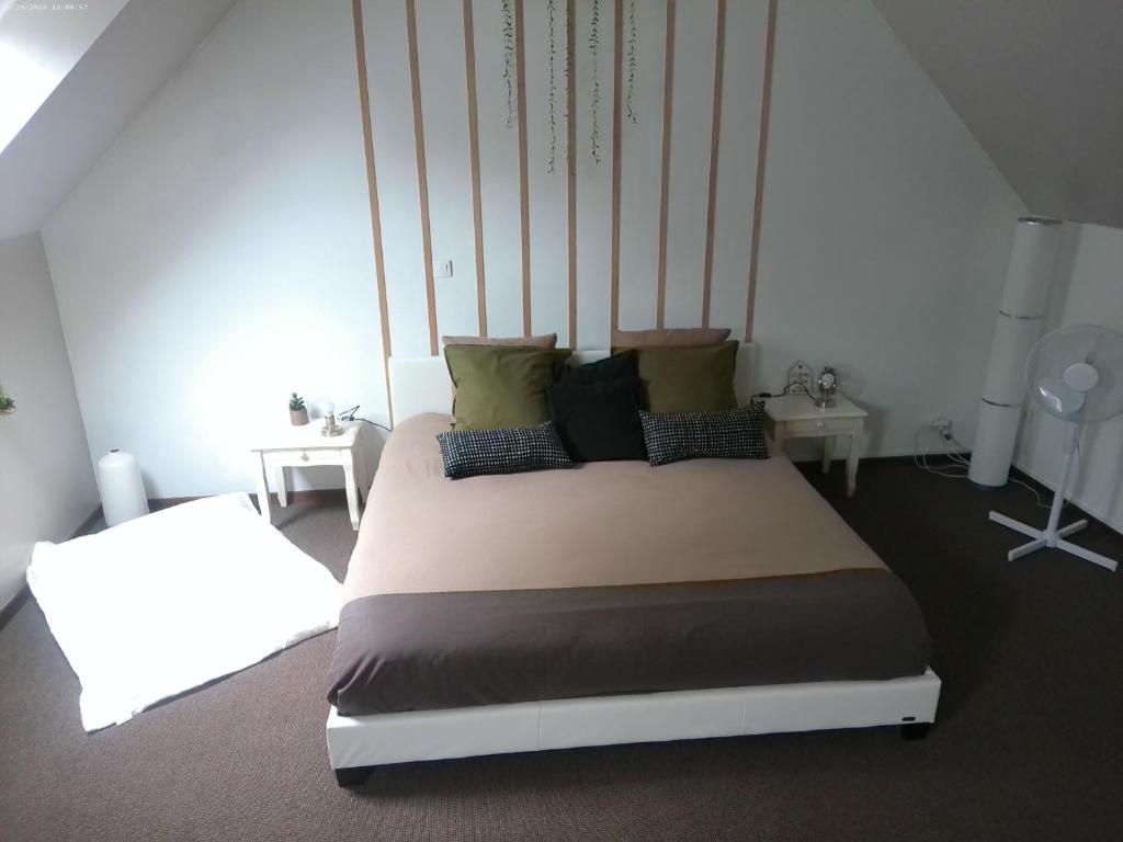a bedroom with a large bed with pillows on it at A 2 pas d AZAY in Neuil