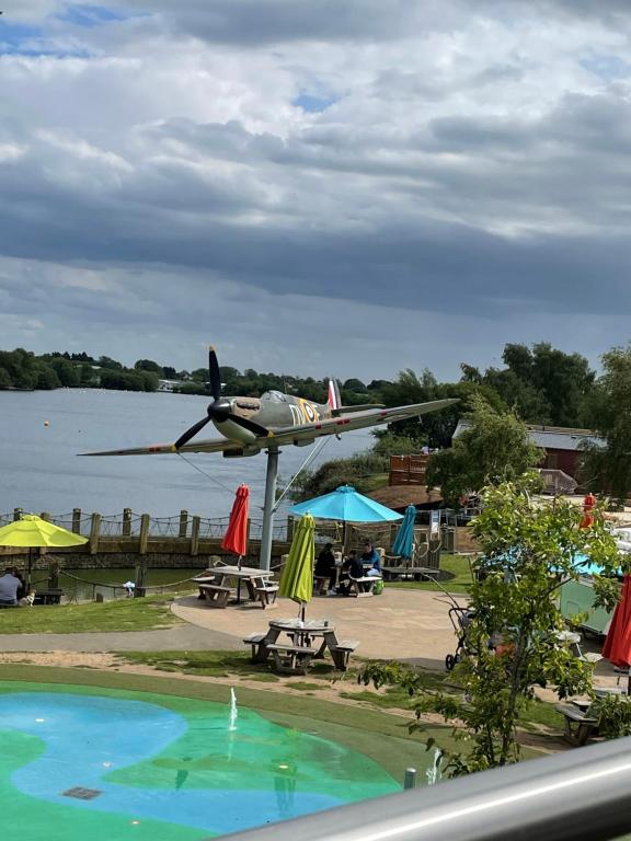 a small plane parked next to a swimming pool at David's place at Tattershall lakes in Tattershall