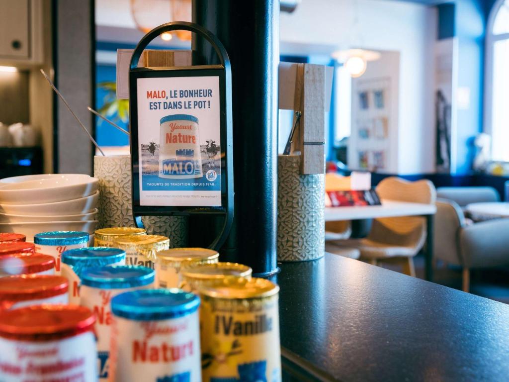 a counter with jars of food on a table at ibis Saint Malo Plage in Saint Malo