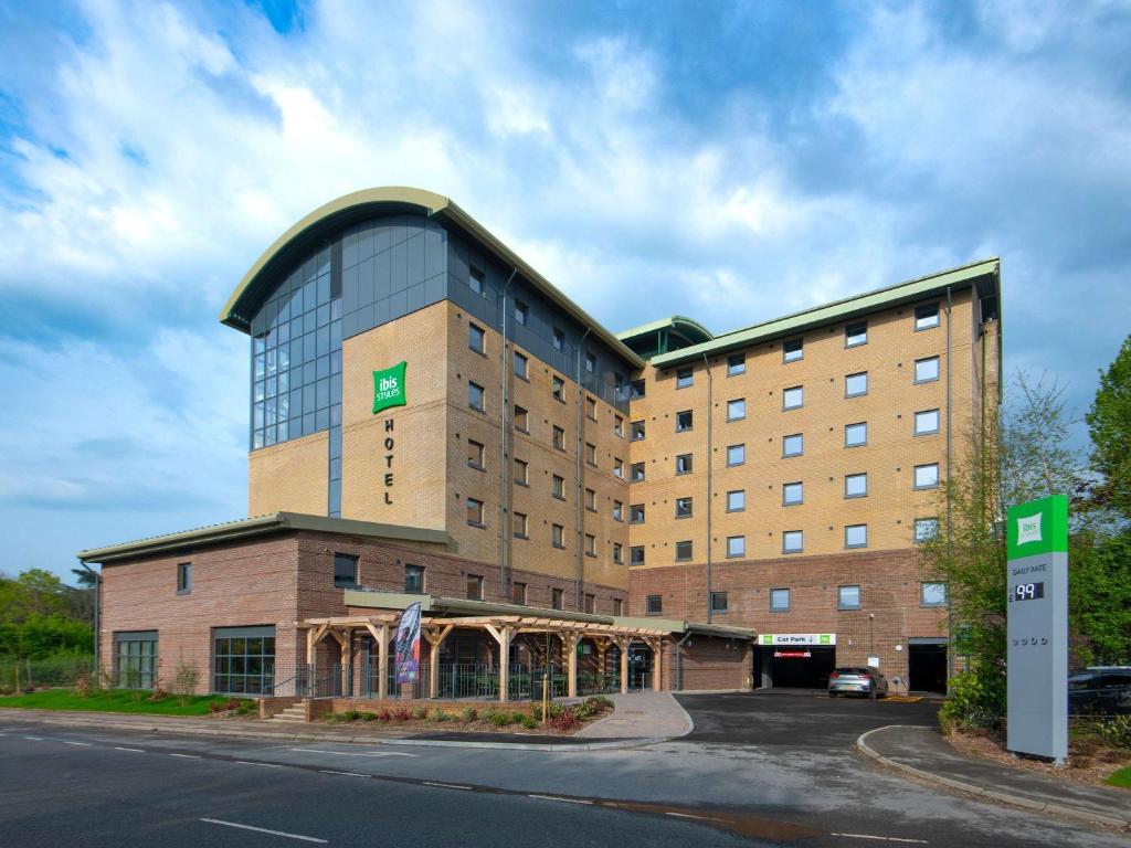 a hotel with a large building on the side of the road at ibis Styles London Gatwick Airport in Crawley