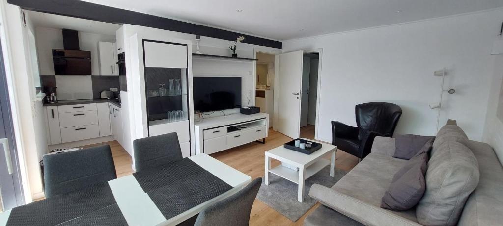 a living room with a couch and a table at Bungalow 2243 in Tossens in Butjadingen