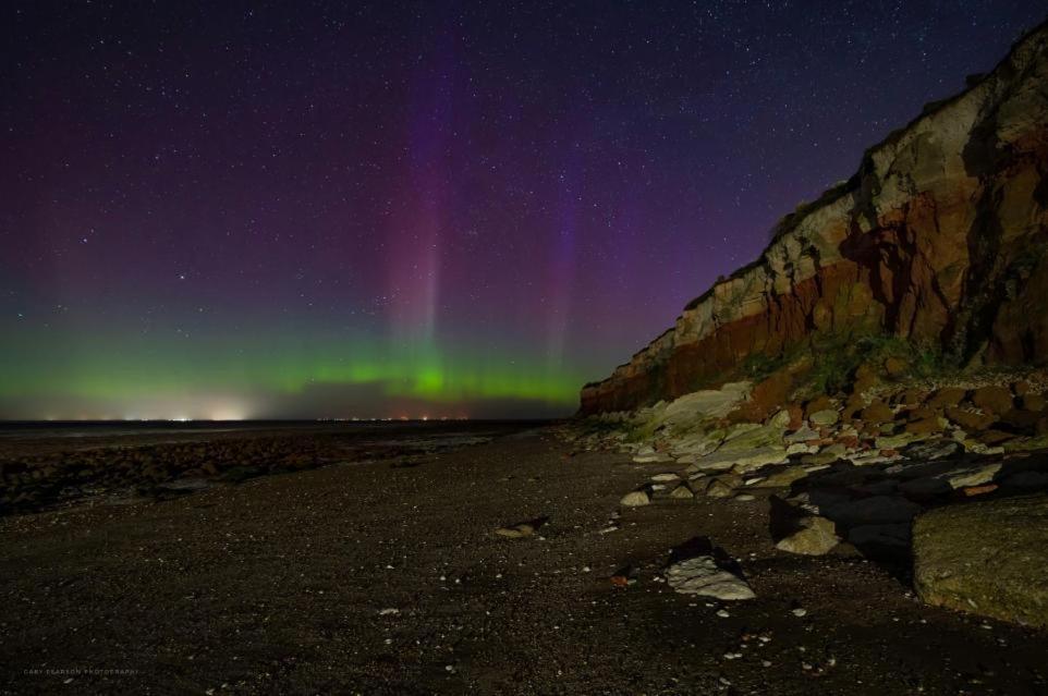 an aurora over the beach at night at Thistledew in Hunstanton