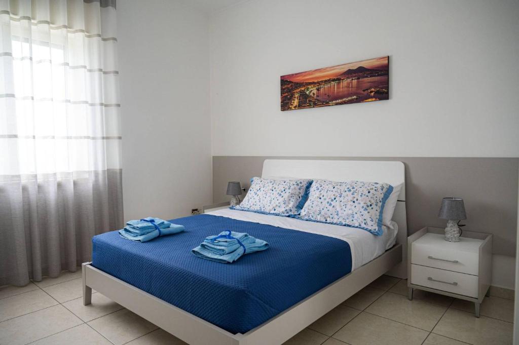 a bedroom with a bed with two towels on it at Mare Fuori casa vacanze in Castellammare di Stabia
