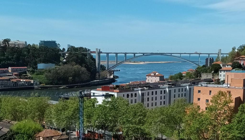 a bridge over a body of water with buildings at Vilar Oporto Hotel in Porto