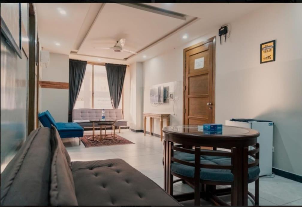 a living room with a couch and a table at Vaporium 2 bedroom Apartment in Rawalpindi