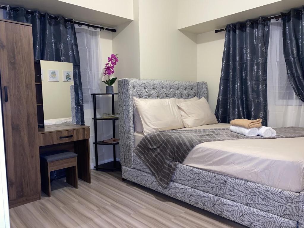 Postel nebo postele na pokoji v ubytování Avida Riala 1BR unit- IT Park Cebu City