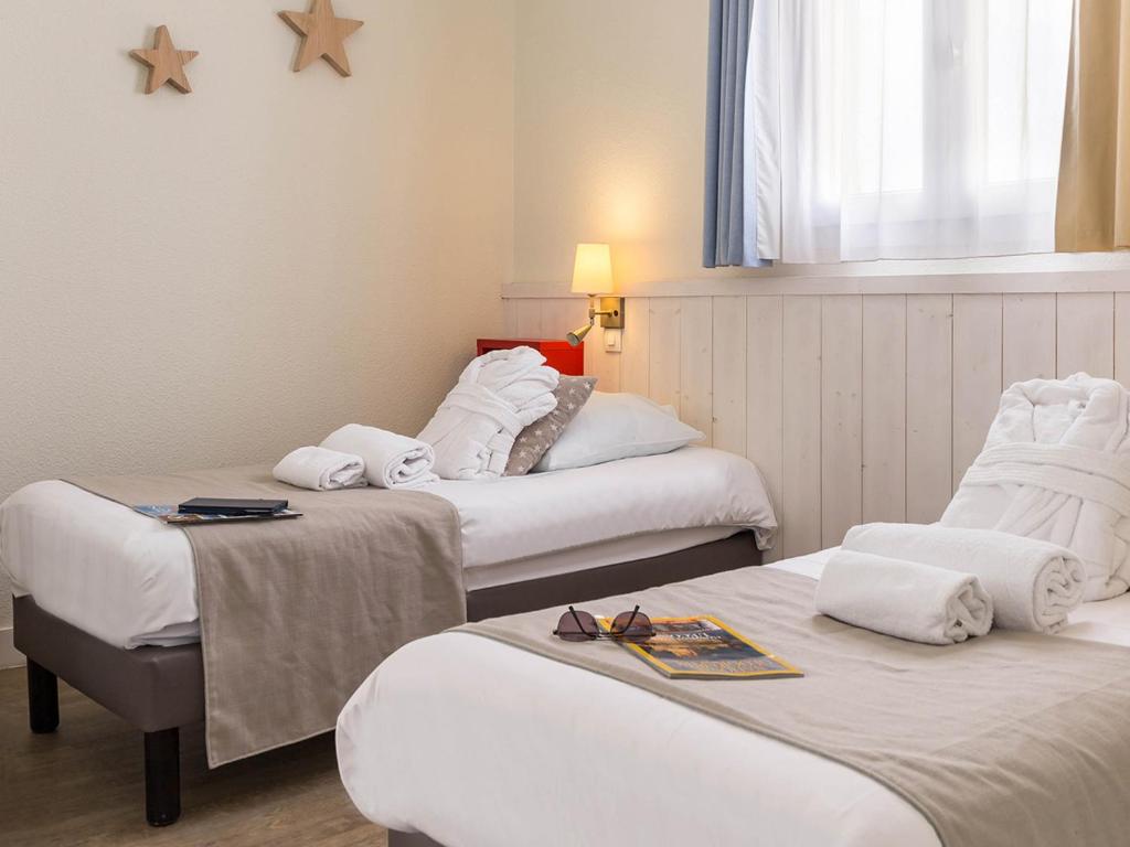 Postel nebo postele na pokoji v ubytování Résidence Pierre & Vacances Le Palais des Gouverneurs