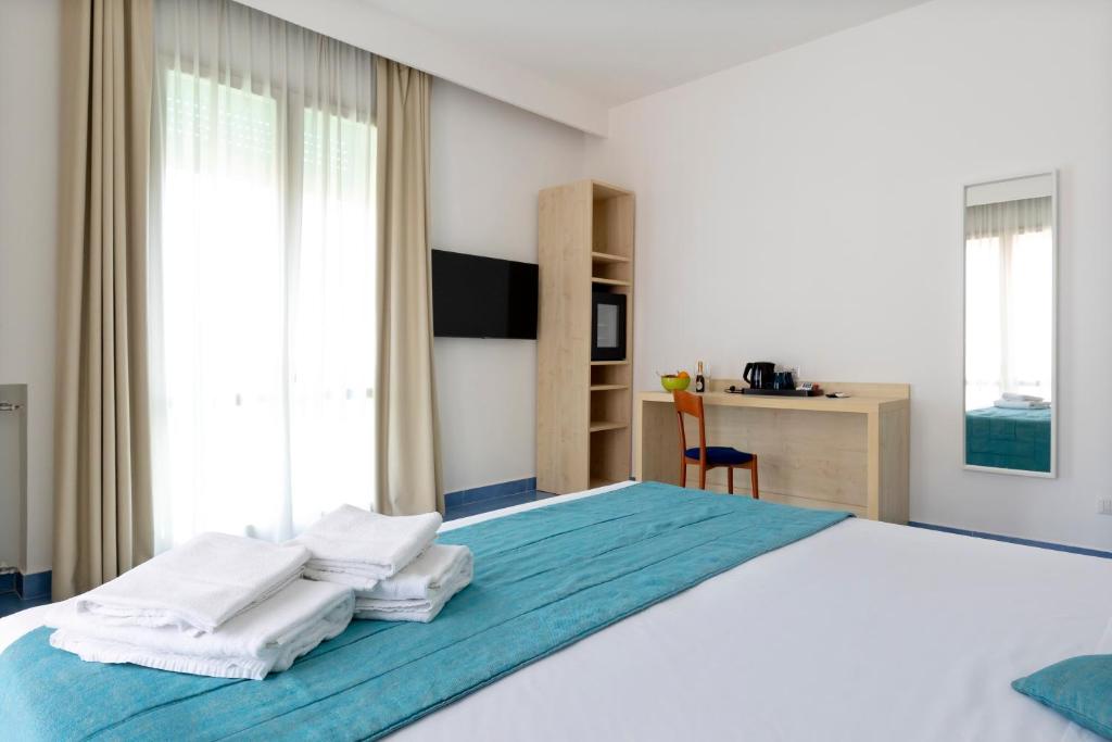 Postel nebo postele na pokoji v ubytování Napolit'amo Hotel Medina