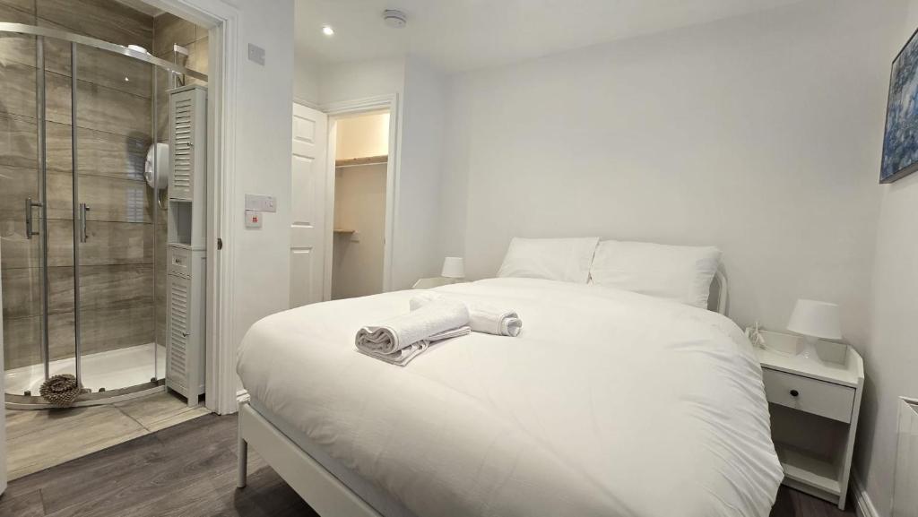 a bedroom with a large white bed and a shower at Central & Stylish, Two Bed, Two Bath in Galway