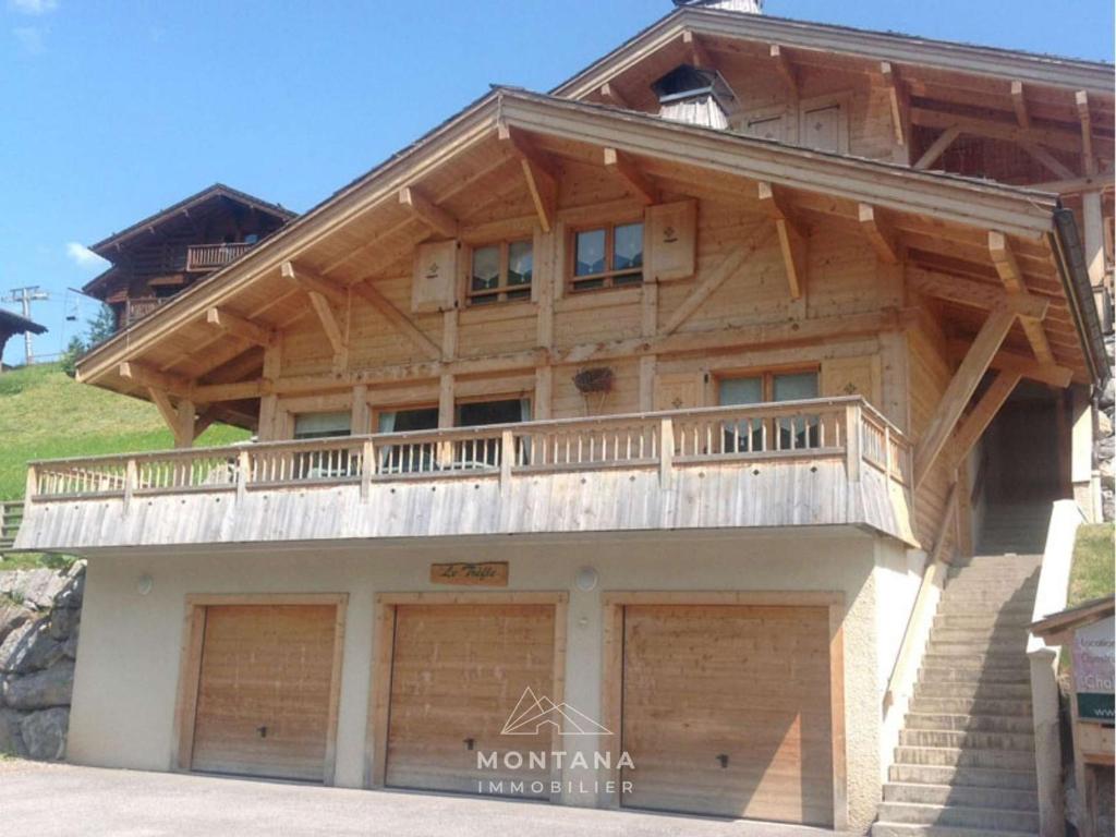 a large wooden house with two garage at Triplex 8 pers. en Chalet Traditionnel, Pied des Pistes, Terrasse, Balcon, Parking - FR-1-458-164 in Le Grand-Bornand