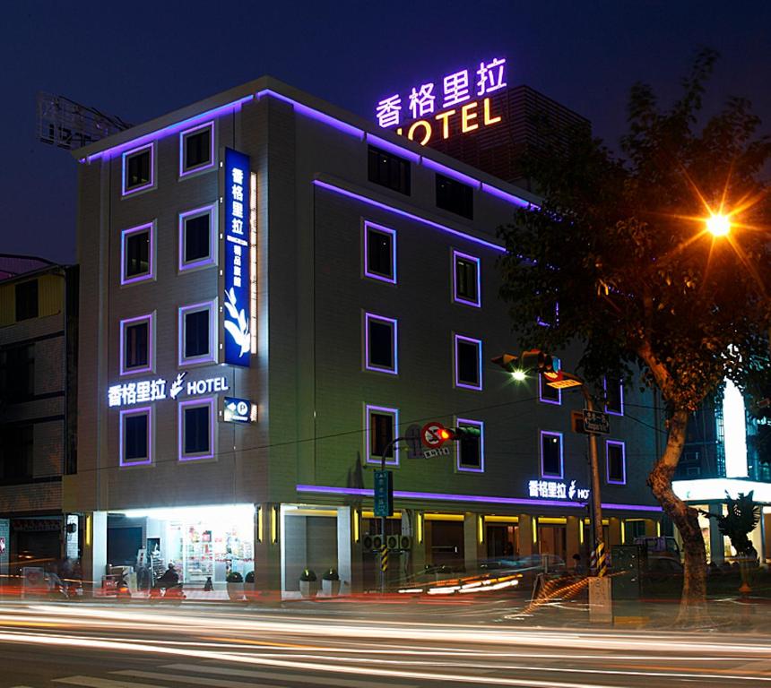 a building with neon signs on the side of it at Hsiangkelira Hotel in Kaohsiung