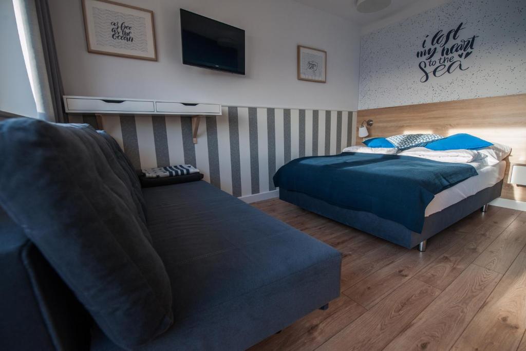 Postel nebo postele na pokoji v ubytování Lazur Apartamenty Domki