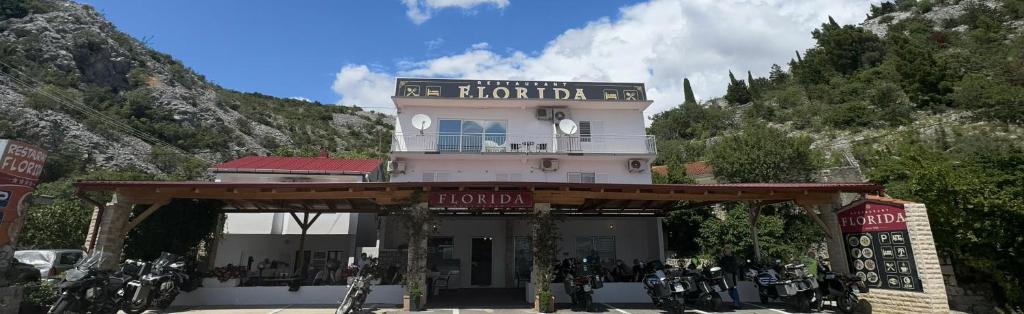 a building with motorcycles parked in front of it at Rooms Florida in Tribanj-Krušćica