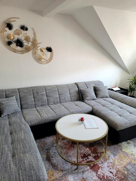 a living room with a couch and a table at 75qm Apartment in Burgstaedt