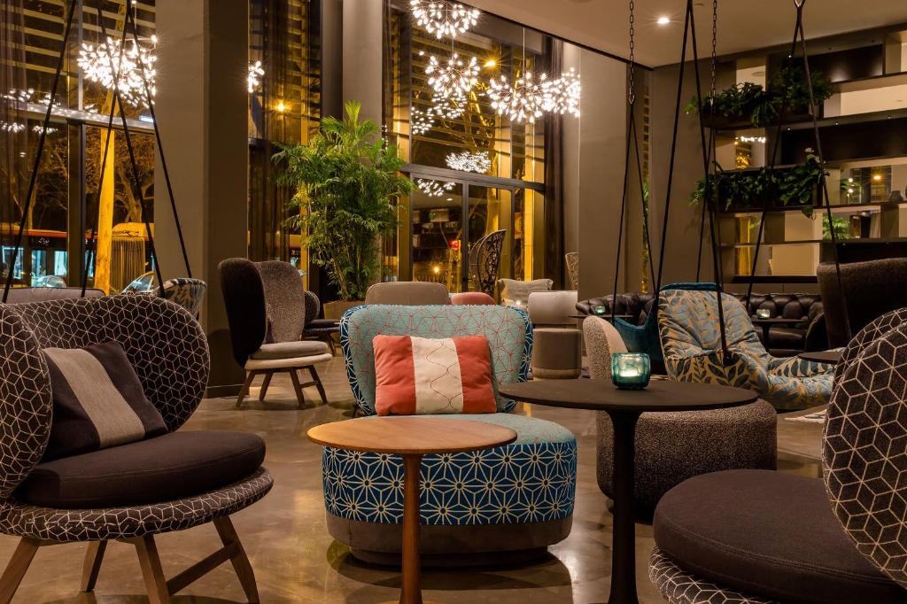 a store with chairs and tables in a room at Motel One Barcelona-Ciutadella in Barcelona