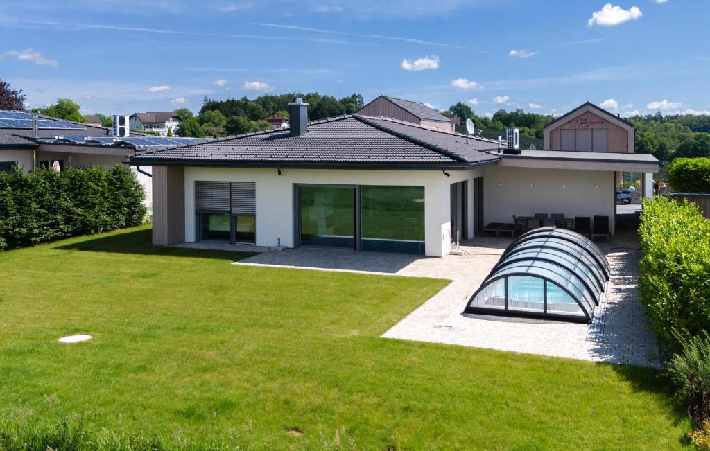 a house with a lawn and a pool at Villa Mit Pool In Stegersbach in Neudauberg