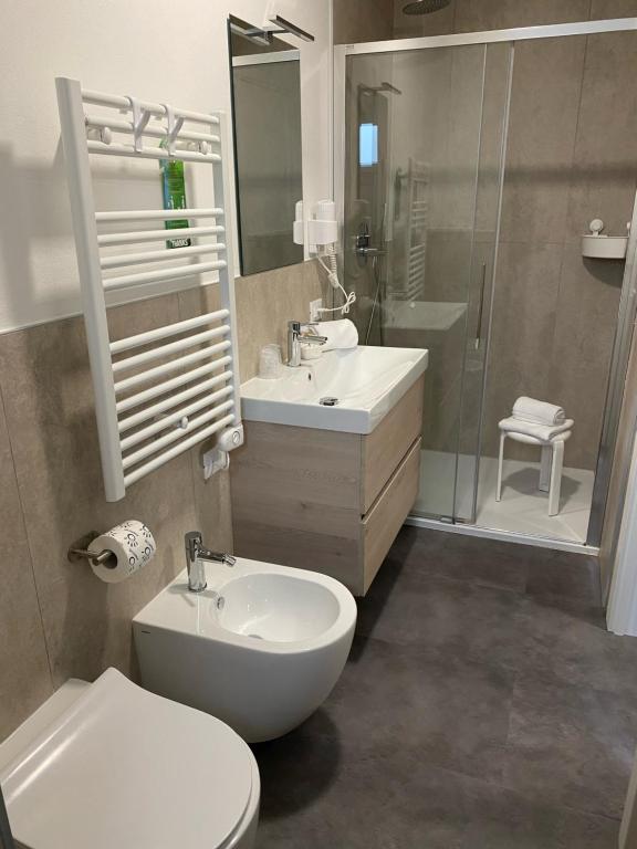 a bathroom with a toilet and a sink and a shower at Boutique Hotel Nuovo Cason in Cavallino-Treporti