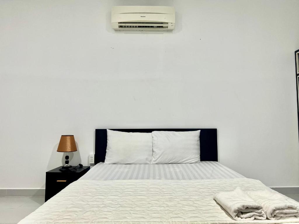een slaapkamer met een bed met airconditioning aan de muur bij MARIA HOTEL in Ba Tri