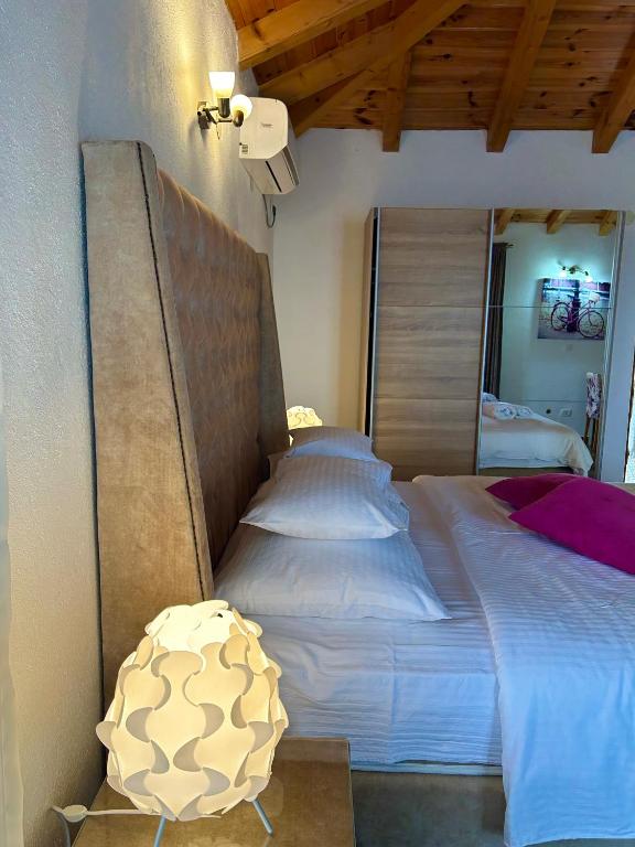 a bedroom with a large bed in a room at Harmonia Bungalows & Pool in Sveti Stefan