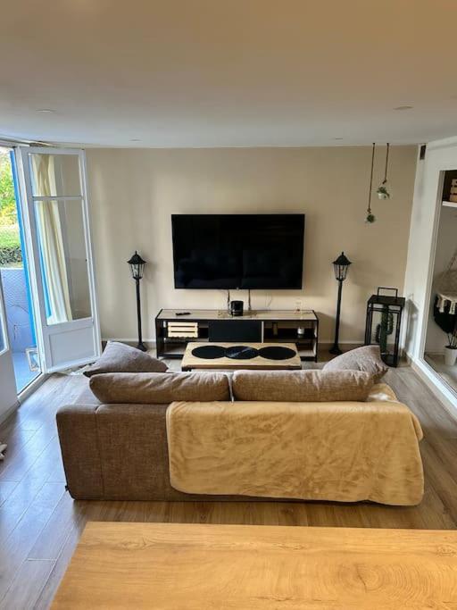 un salon avec un canapé et une télévision à écran plat dans l'établissement Appartement, à Marseille