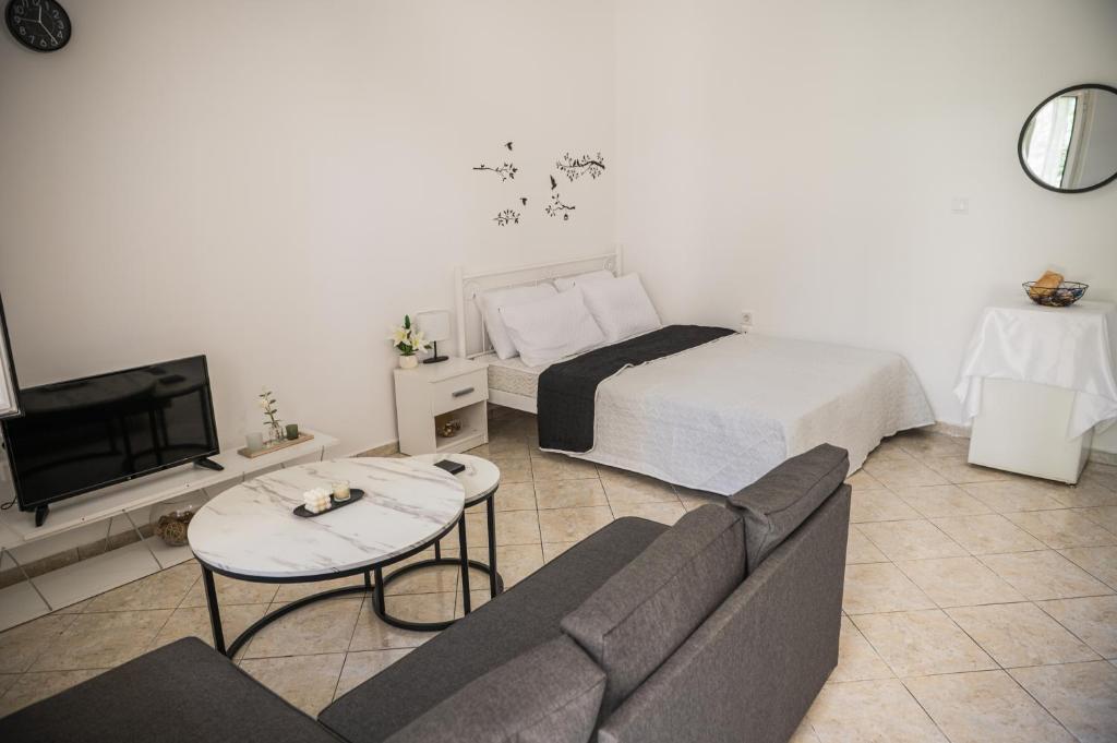 a living room with a couch and a bed at Happy Room-2' from sea in Kalamata