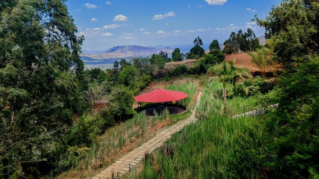 a red umbrella sitting on top of a hill at Terra on a hill in Panchgani