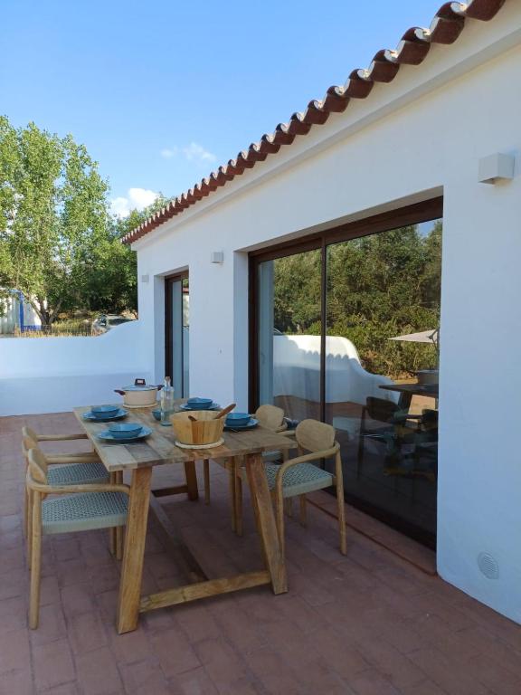 a wooden table and chairs on a patio at Casa da Azeitona T1 - Monte do Serrado de Baixo in Évora