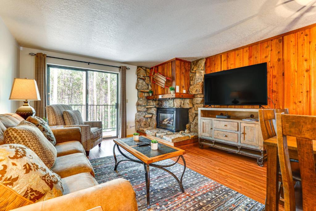 a living room with a couch and a television at Winter Park Condo w/ Resort Shuttle On-Site! in Winter Park