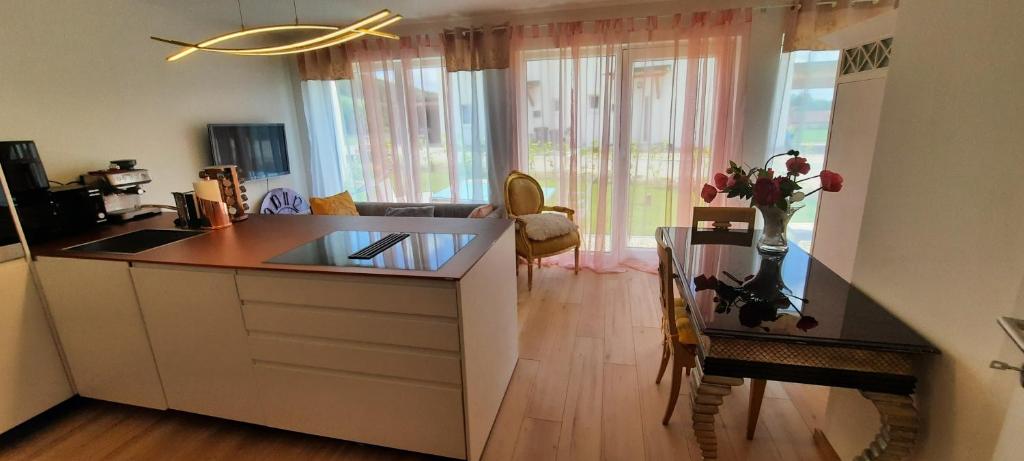 a kitchen with a counter and a table in a room at Exklusiv Ferienwohnung Nähe Europas größtem Baumkronenweg in Diersbach